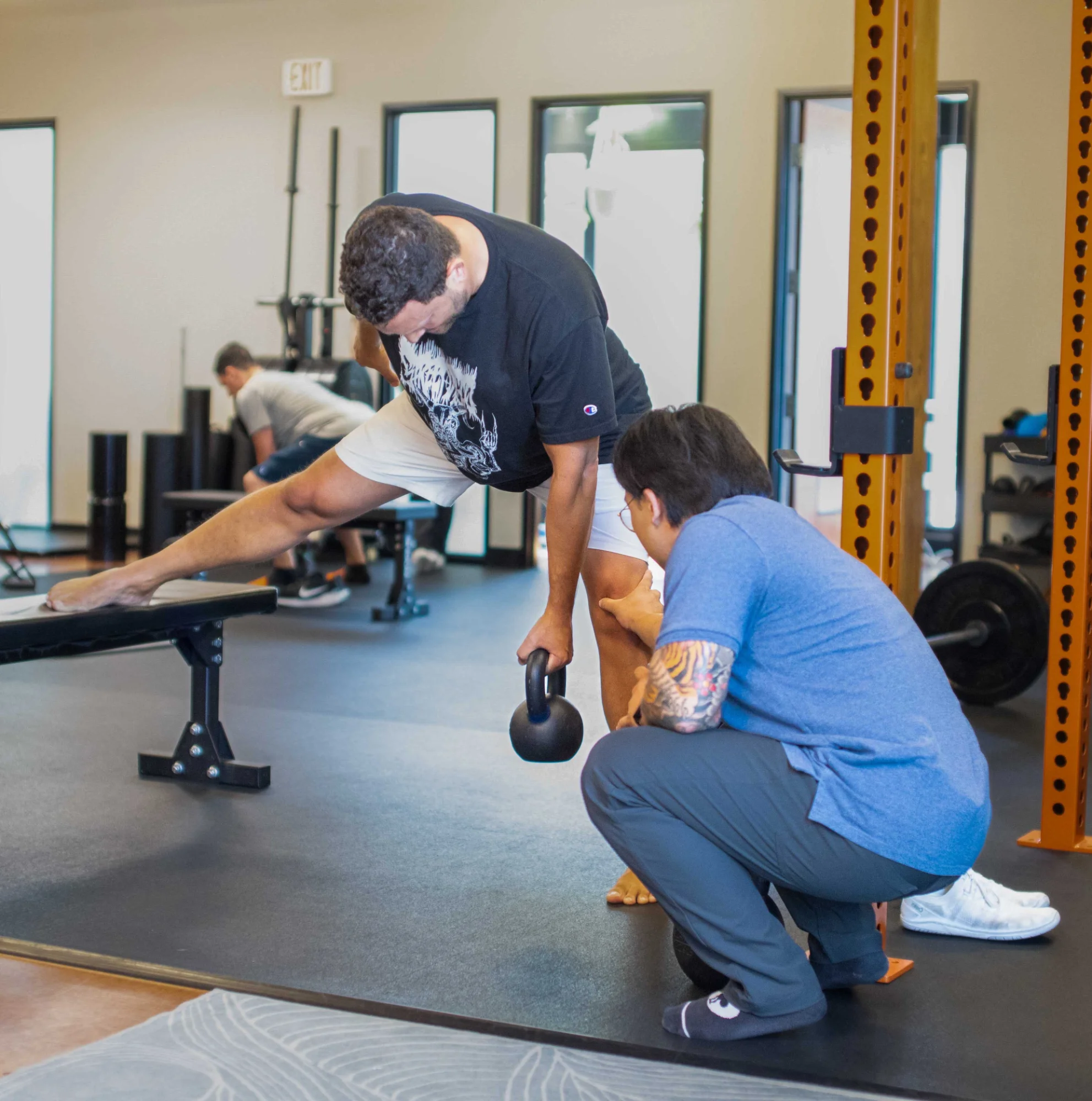 Dr. Q assessing a patient's knee during a Move Better session